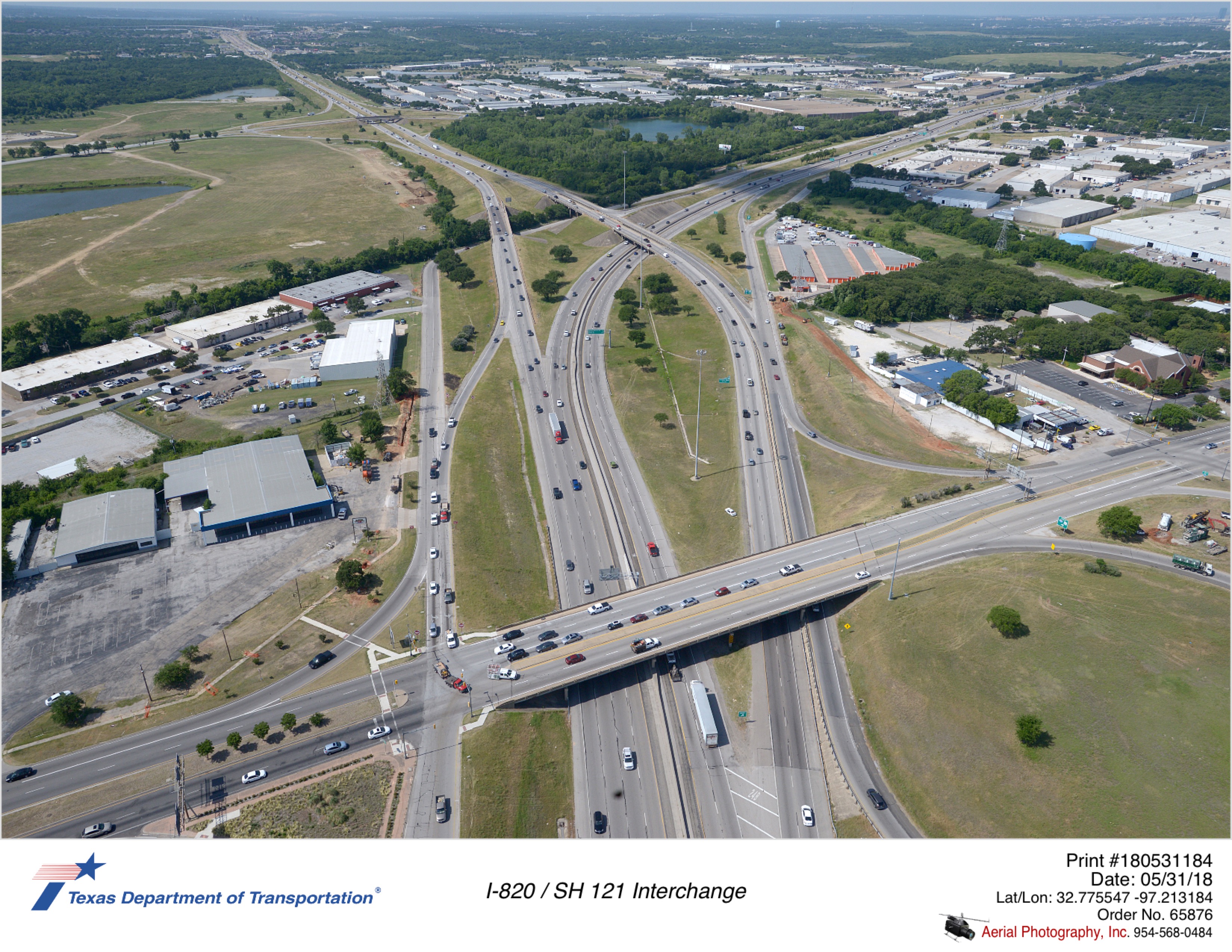 Aerial view taken May 2018 of I-820/SH 121 interchange. Foreground is of SH 10/Hurst Boulevard interchange. Split of SH 121 and I-820 is visible in background.