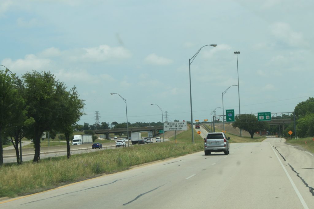 SH 121 northbound frontage road showing access ramp to I-820 and regulatory sign that vehicles over 45 feet in length are prohibited.