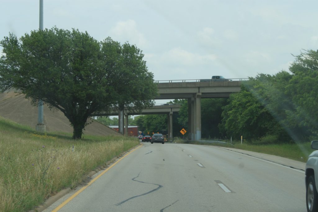 SH 121 northbound frontage road approaching I-820 overpass.