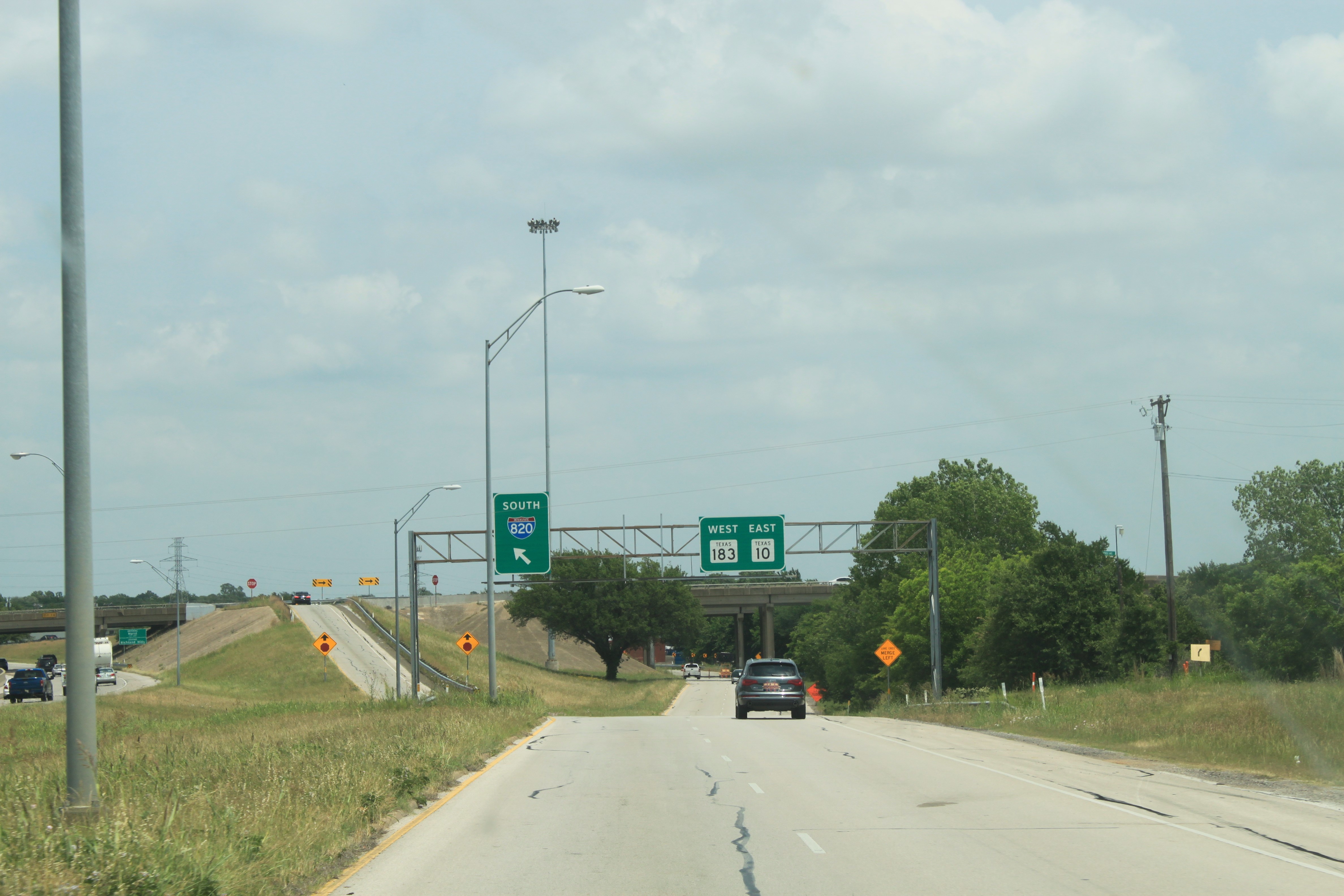 SH 121 northbound frontage road approaching ramp to access I-820 southbound or continue to Hurst Blvd