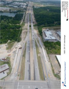 I-820 looking north over Randol Mill Rd. Construction of new access ramps north of Randol Mill Rd and new I-820 mainlane bridges over the Trinity River seen.