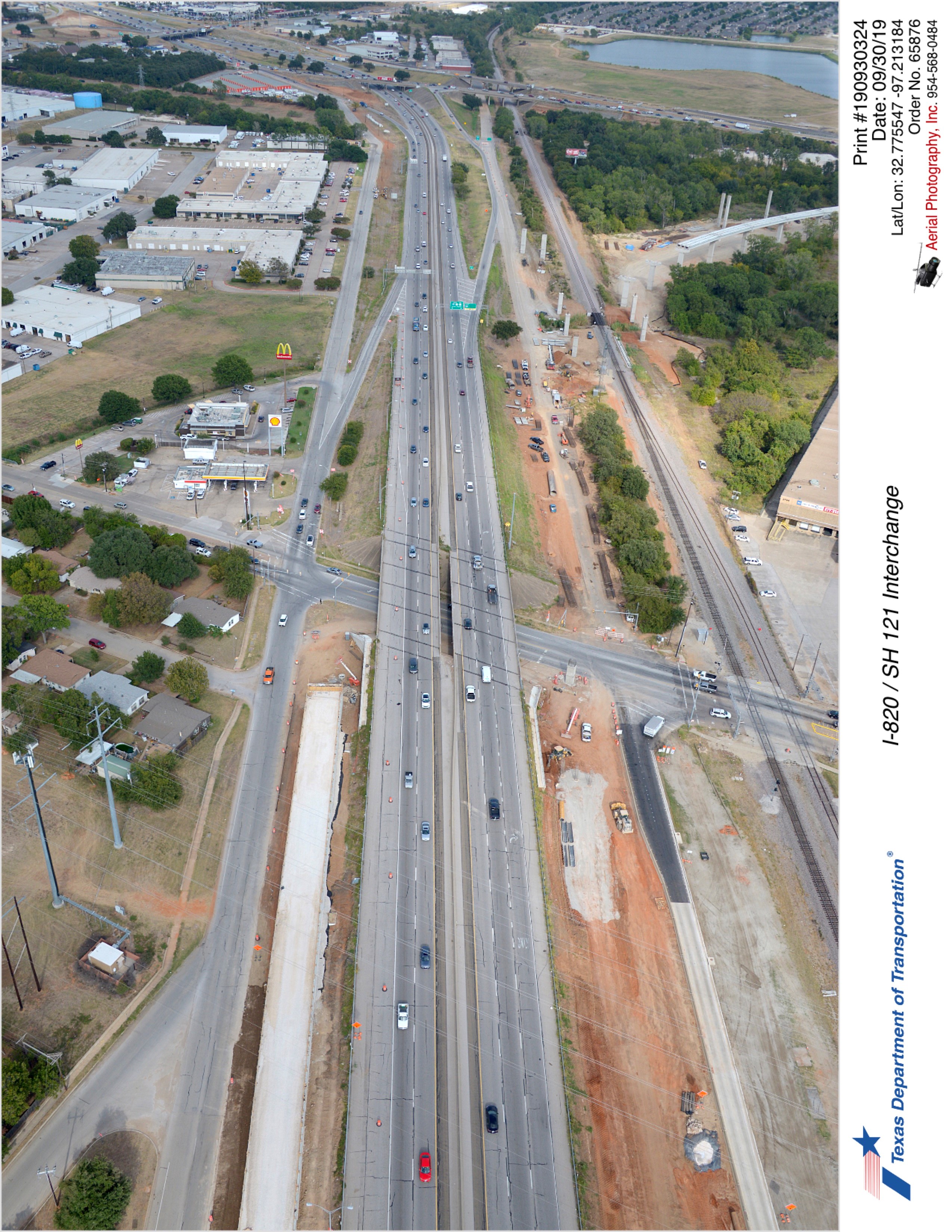 SH 121 looking northeast over Handley-Ederville Rd intersection. Construction on north and south side of SH 121 west of Handley-Ederville Rd and bridge construction over northbound frontage road east of Handley-Ederville Rd.