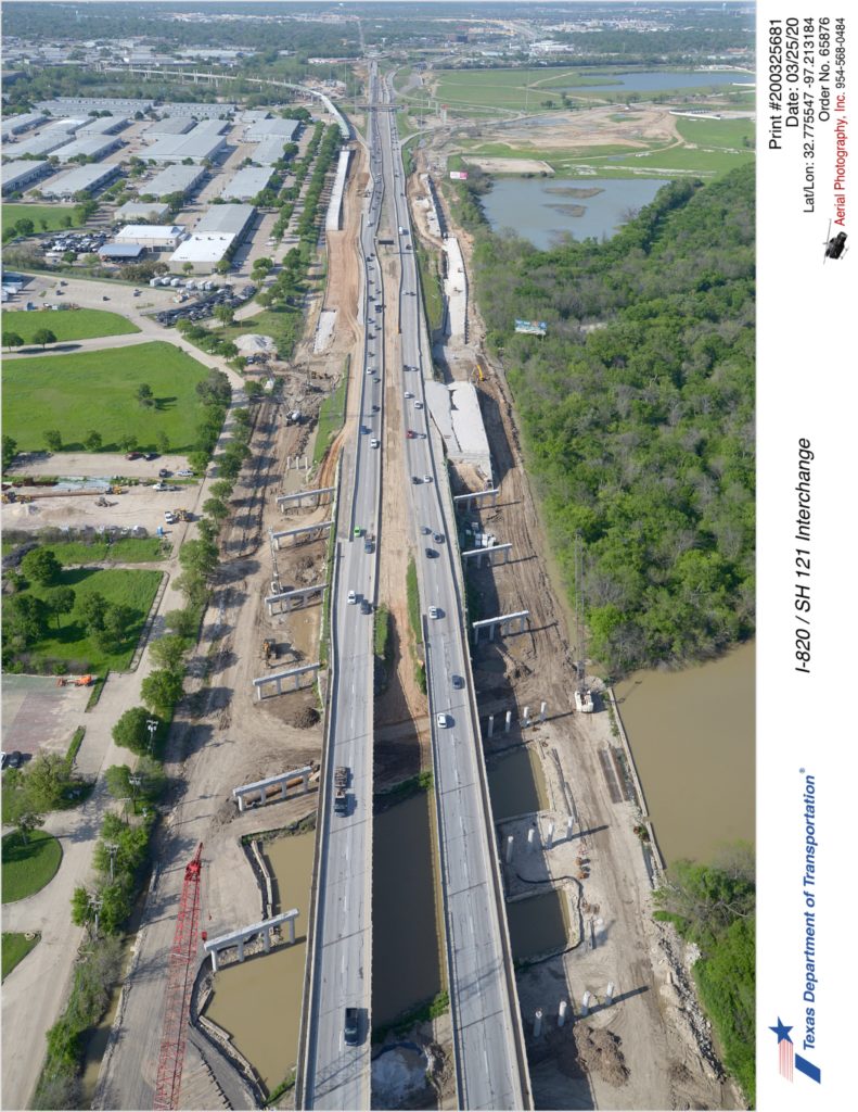 I-820 looking north over the Trinity River. Construction of bridge substructure for southbound and northbound mainlanes is shown.