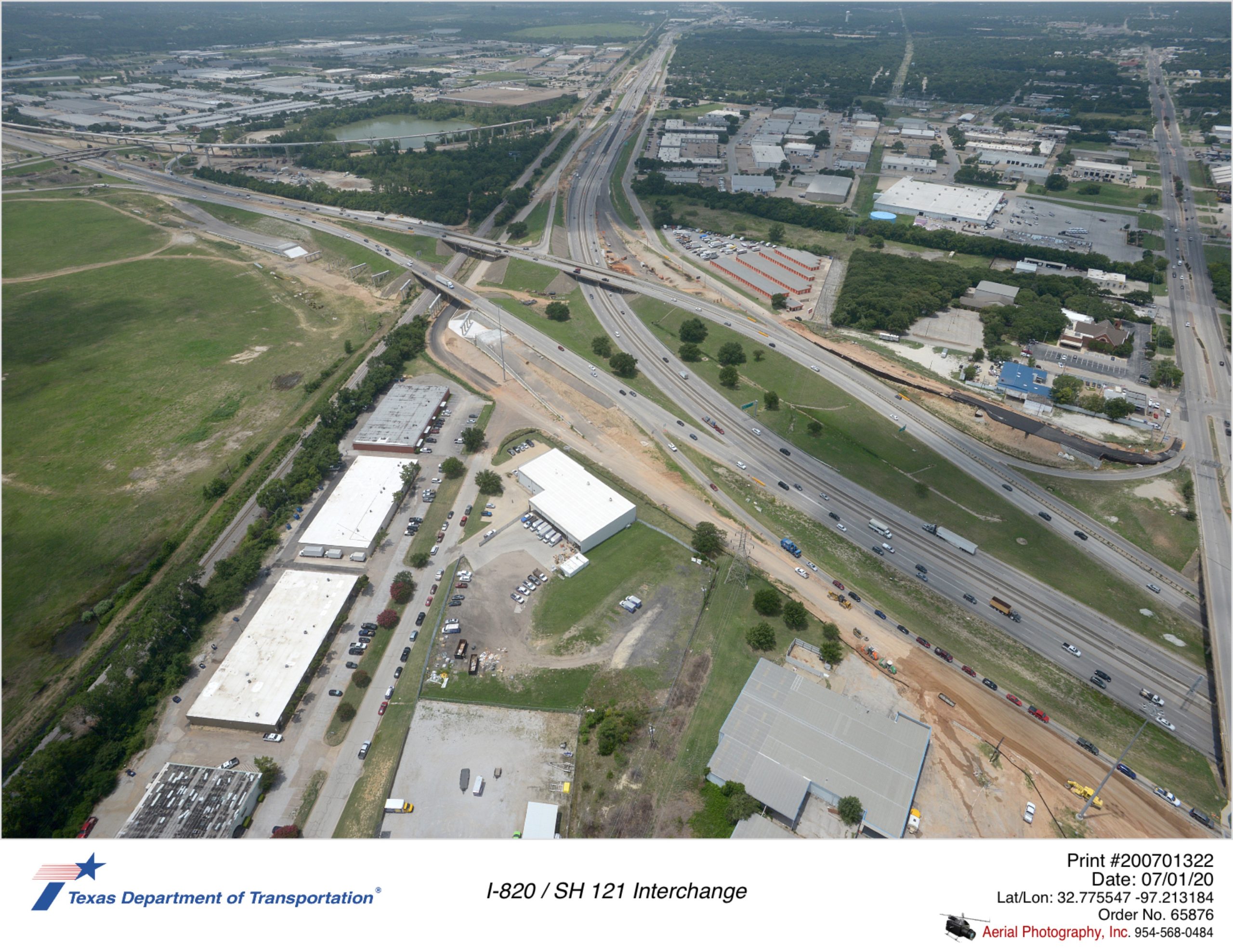 Looking southwest over I-820/SH 121 interchange. Construction of northbound frontage road shown.