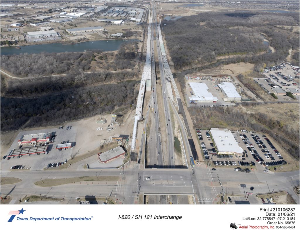 I-820 looking north over Randol Mill Rd. Construction of new mainlane bridge structures over the Trinity River are shown.
