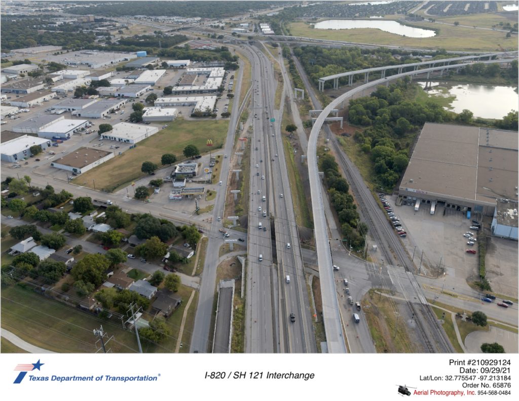 SH 121 looking northbound over Handley-Ederville Rd interchange. Construction of direct connector ramps to and from SH 121 are shown.