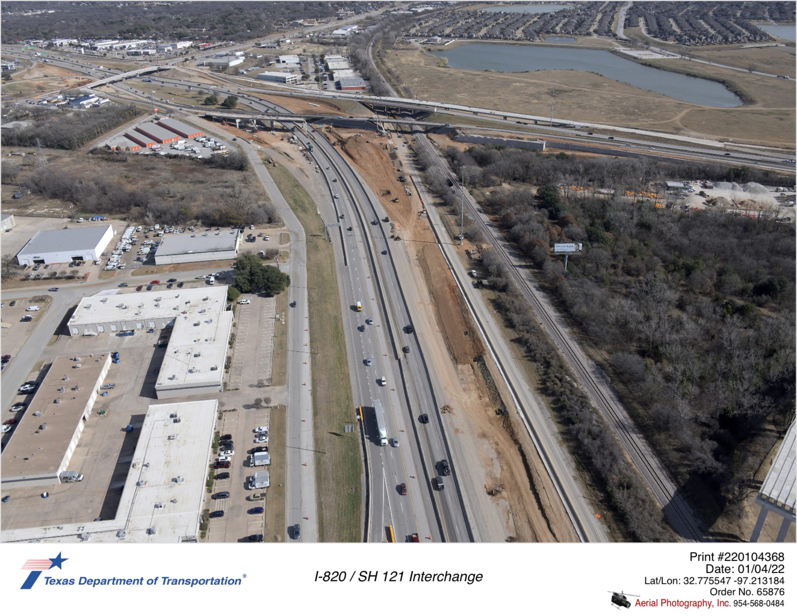SH 121 looking northeast at I-820/SH 121 interchange. Construction of new I-820 bridges over SH 121 and Trinity Rail Express shown.