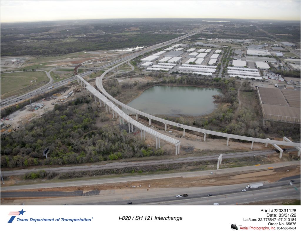 SH 121 and I-820 shown looking south southeast at direct connector ramps between the two highways. Progress shown on the north-to-south ramp.