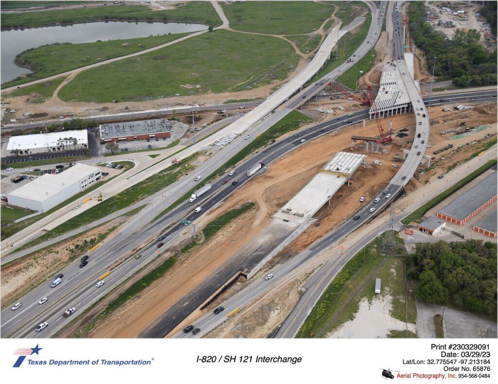I-820 and SH 121 interchange highlighting construction of future I-820 southbound mainlanes over SH 121.  March 2023.