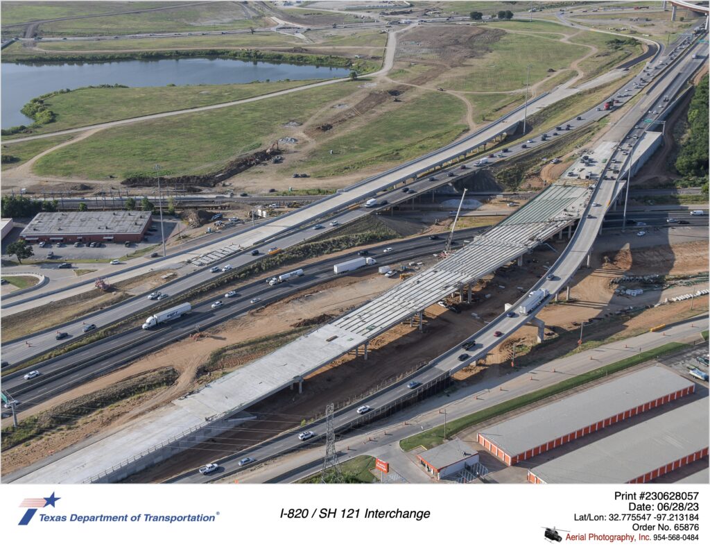 I-820 and SH 121 interchange looking southeast. Image shows construction of new southbound mainlane bridge over SH 121.