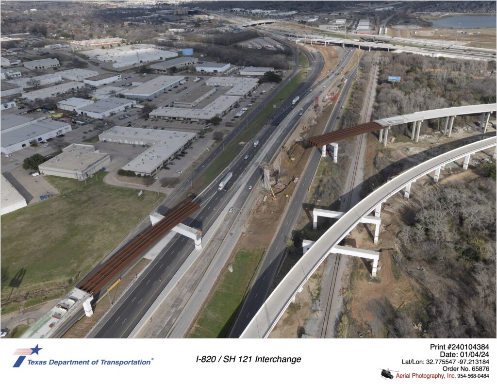 SH 121 looking northeast at the I-820 interchange in the background and direct connector ramp construction over SH 121.